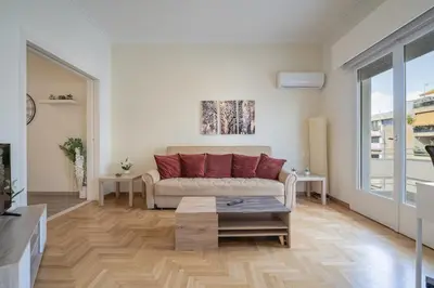 a living room with a couch and a table at Nea Smyrni 1 BDRM - Links To City Center by ΜΡS in Athens