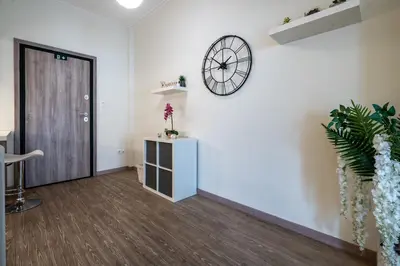 an office with a clock on the wall and a door at Nea Smyrni 1 BDRM - Links To City Center by ΜΡS in Athens