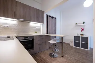 a kitchen with wooden cabinets and a counter top at Nea Smyrni 1 BDRM - Links To City Center by ΜΡS in Athens