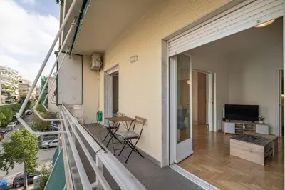 a balcony with a living room and a television at Nea Smyrni 1 BDRM - Links To City Center by ΜΡS in Athens