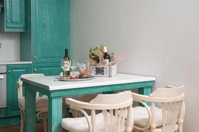 a kitchen with a table with chairs and wine bottles at Casa Marina in Porto Rafti