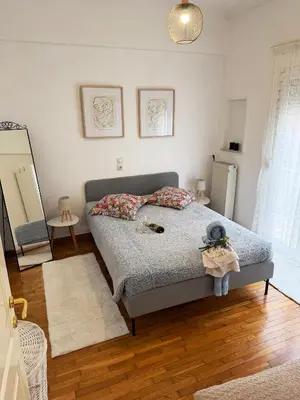 a bedroom with a bed and a mirror in it at Felicias Cozy Exarchia Apartment Pet Friendly in Athens