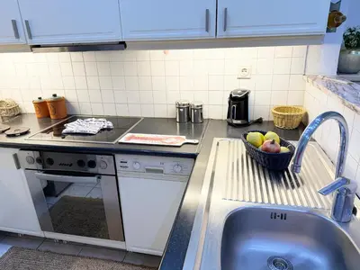 a kitchen with a sink and a bowl of fruit at Felicias Cozy Exarchia Apartment Pet Friendly in Athens