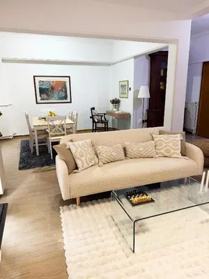 a living room with a couch and a table at Felicias Cozy Exarchia Apartment Pet Friendly in Athens