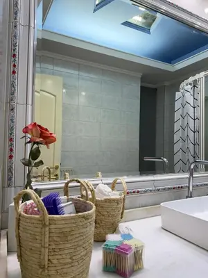a bathroom with baskets and a sink and a mirror at Felicias Cozy Exarchia Apartment Pet Friendly in Athens