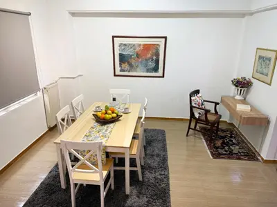 a dining room with a table with a bowl of fruit on it at Felicias Cozy Exarchia Apartment Pet Friendly in Athens