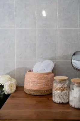 a basket of towels sitting on a counter in a bathroom at Livingstone House in Porto Rafti