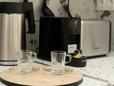 two glasses on a cutting board next to a coffee maker at Apartment Athen von unserem Haus aus- wenige Schritte von der Akropolis entfernt by Interhome in Athens