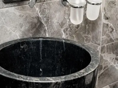 a black tub in a bathroom with a sink at Apartment Athen von unserem Haus aus- wenige Schritte von der Akropolis entfernt by Interhome in Athens
