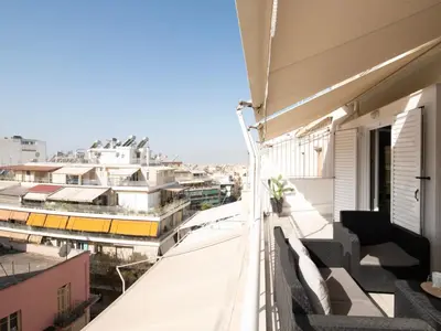 a balcony with a view of a city with buildings at Apartment Athen von unserem Haus aus- wenige Schritte von der Akropolis entfernt by Interhome in Athens