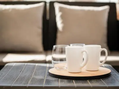 a wooden table with two cups and a glass at Apartment Athen von unserem Haus aus- wenige Schritte von der Akropolis entfernt by Interhome in Athens
