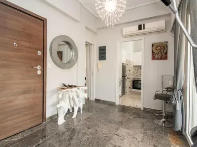 a hallway with a wooden door and a mirror at Apartment Athen von unserem Haus aus- wenige Schritte von der Akropolis entfernt by Interhome in Athens