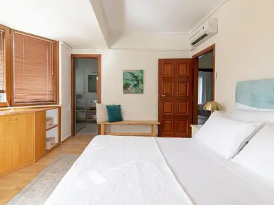 a bedroom with a large bed and a desk at Holiday Home Villa Stefani mit privatem Pool by Interhome in Athens