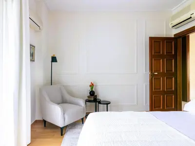 a bedroom with a bed and a chair and a window at Holiday Home Villa Stefani mit privatem Pool by Interhome in Athens