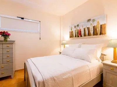 a bedroom with a bed and a dresser and a window at Holiday Home Villa Stefani mit privatem Pool by Interhome in Athens
