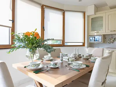 a dining room table with a vase of flowers at Holiday Home Villa Stefani mit privatem Pool by Interhome in Athens