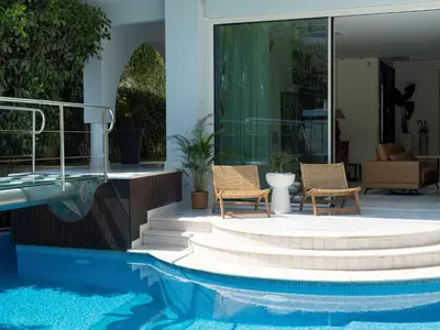 a house with two chairs and a swimming pool at Holiday Home Villa Stefani mit privatem Pool by Interhome in Athens