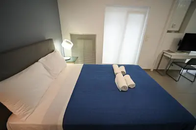 a bedroom with a large bed with towels on it at Kolonaki Urban Gem by Zeus Suites in Athens