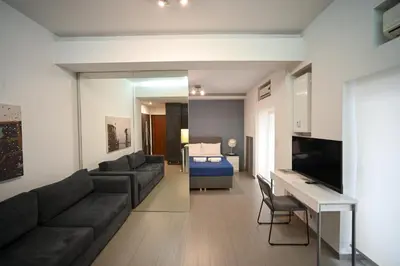 a living room with a couch and a table at Kolonaki Urban Gem by Zeus Suites in Athens