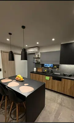 a kitchen with a table with a bowl of fruit on it at Sunshine houses in Athens