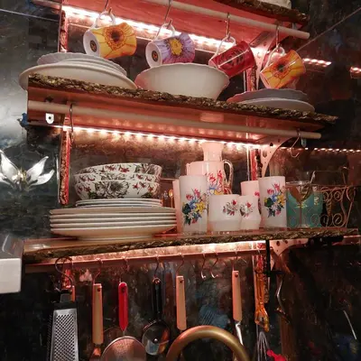 a shelf with plates and utensils in a kitchen at My House of Inspiration in Athens by the sea in Athens