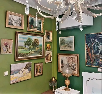 a wall full of pictures on a green wall at My House of Inspiration in Athens by the sea in Athens