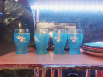a group of four blue glasses sitting on a table at My House of Inspiration in Athens by the sea in Athens