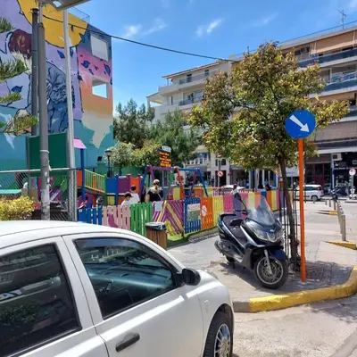 a white car parked in front of a playground at My House of Inspiration in Athens by the sea in Athens