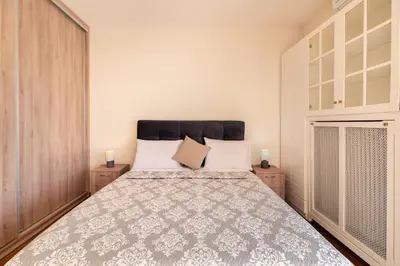 a bedroom with a large bed in a room at Seaside Dublex with 2 Large Terraces Walk to the Beach in Piraeus
