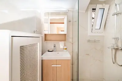 a bathroom with a sink and a shower at Seaside Dublex with 2 Large Terraces Walk to the Beach in Piraeus