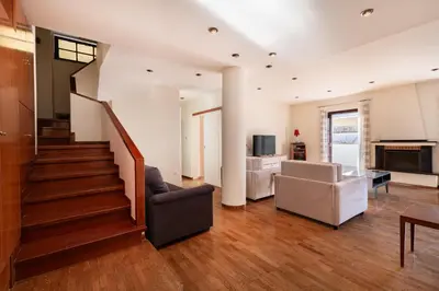 a living room with a staircase and a couch at Seaside Dublex with 2 Large Terraces Walk to the Beach in Piraeus