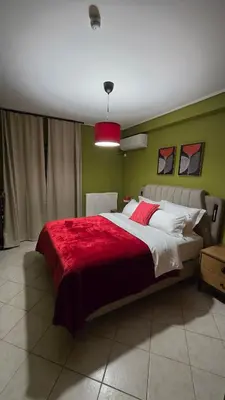 a bedroom with a large bed with a red blanket at Piraeus Gate - PS5 in Piraeus