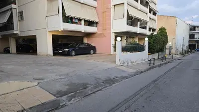 a black car parked in front of a building at Piraeus Gate - PS5 in Piraeus