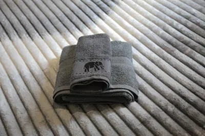 a pile of towels on top of a bed at Casa Urbana in Athens