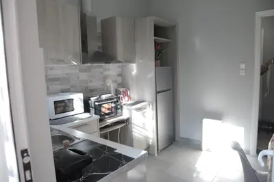 a small kitchen with a refrigerator and a microwave at Casa Urbana in Athens