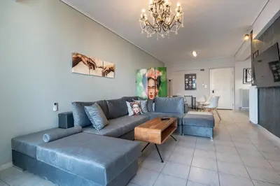 a living room with a blue couch and a table at Family 2BRM Flat in Patissia-Acropolis View by ΜΡS in Athens