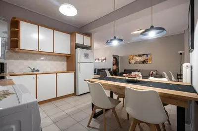 a kitchen with a table and chairs in a kitchen at Family 2BRM Flat in Patissia-Acropolis View by ΜΡS in Athens