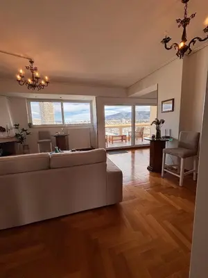 a large living room with a couch and a table at Athens Sky Penthouse in Athens