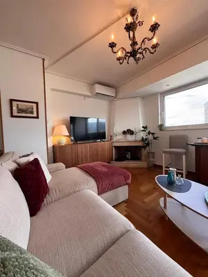 a living room with two couches and a television at Athens Sky Penthouse in Athens