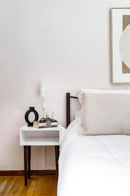 a bed with a nightstand next to a white bed at Elegant City Retreat with Two Balconies in Athens