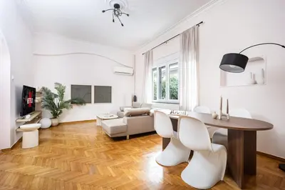a white living room with a table and chairs at Elegant City Retreat with Two Balconies in Athens