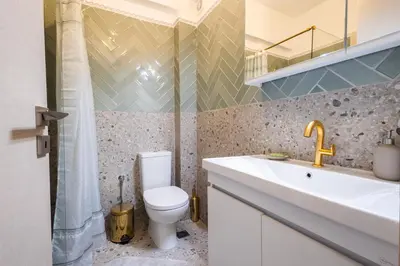 a bathroom with a toilet and a sink and a shower at Seaside Home in Porto Rafti