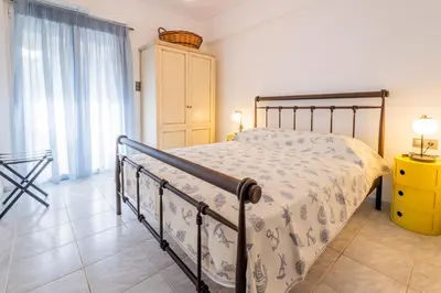 a bedroom with a bed and a yellow cabinet at Seaside Home in Porto Rafti