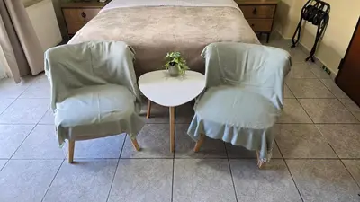 a bedroom with a table and two chairs and a bed at Space One in Piraeus