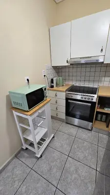 a kitchen with a counter with a microwave and a stove at Space One in Piraeus