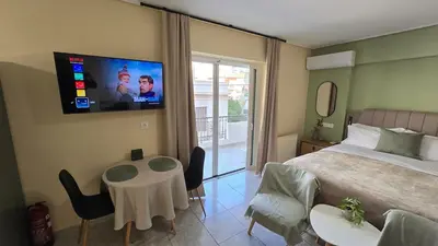 a bedroom with a bed and a tv on the wall at Space One in Piraeus