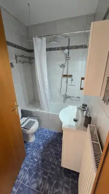 a bathroom with a sink and a toilet and a shower at Space One in Piraeus
