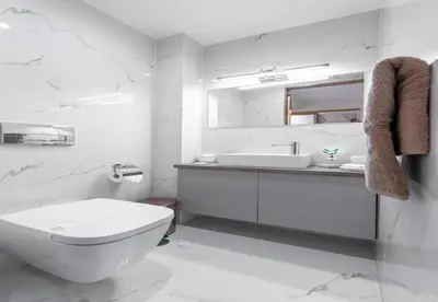 a white bathroom with a toilet and a sink at LuxuryStay Koukaki up to 10 guests in Athens