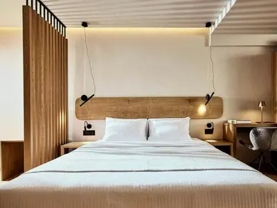 a bedroom with a large white bed and a desk at Comfort and Relaxation in Athens