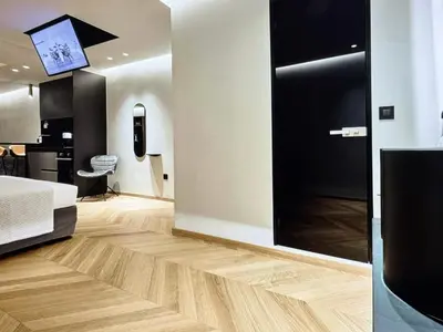 a bedroom with a bed and a tv on a wall at Comfort and Relaxation in Athens